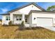 Exterior of home boasts a modern elevation, attached garage, and fresh landscaping at 2436 Jacobs St, Port Charlotte, FL 33953