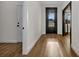Light-filled hallway featuring hardwood floors, neutral walls, and modern doors at 2436 Jacobs St, Port Charlotte, FL 33953