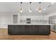 Spacious kitchen features a large island, modern appliances, and elegant pendant lighting at 2436 Jacobs St, Port Charlotte, FL 33953