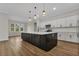 Open-concept kitchen with stainless steel appliances, a large center island, and stylish pendant lighting at 2436 Jacobs St, Port Charlotte, FL 33953