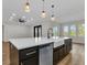 Gourmet kitchen featuring an expansive island, stainless steel appliances, and designer pendant lights at 2436 Jacobs St, Port Charlotte, FL 33953