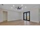 Spacious living room with French doors, modern ceiling fan, and hardwood floors at 2436 Jacobs St, Port Charlotte, FL 33953