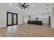 Expansive living area with hardwood floors, modern ceiling fan, and an open-concept design at 2436 Jacobs St, Port Charlotte, FL 33953