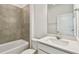 Modern bathroom with tiled shower, vanity with white countertop, and neutral color scheme at 36424 Sespe Creek Ct, Zephyrhills, FL 33540