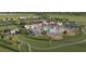 Aerial view of luxurious community pool and amenities with lounge chairs, set amidst lush landscaping and recreational facilities at 36424 Sespe Creek Ct, Zephyrhills, FL 33540