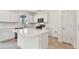 Modern kitchen featuring white cabinetry, stainless steel appliances, and a spacious center island at 36424 Sespe Creek Ct, Zephyrhills, FL 33540