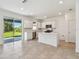 Bright modern kitchen with white cabinets, center island, and stainless steel appliances at 36424 Sespe Creek Ct, Zephyrhills, FL 33540