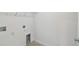 Bright laundry room with neutral walls, tiled floors, and washer/dryer hookups at 36424 Sespe Creek Ct, Zephyrhills, FL 33540