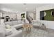 Bright and airy living room featuring neutral tones, modern decor and an open-concept floor plan at 36424 Sespe Creek Ct, Zephyrhills, FL 33540