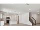 Open-concept living space featuring a modern kitchen, dining area, and staircase at 36424 Sespe Creek Ct, Zephyrhills, FL 33540
