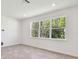 Bright room with large window overlooking trees, featuring neutral walls and flooring at 36424 Sespe Creek Ct, Zephyrhills, FL 33540