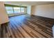Spacious living room with large windows offering views of the waterway and new flooring at 6075 Shore S Blvd # 605, Gulfport, FL 33707