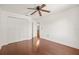 Bright bedroom featuring hardwood floors, a ceiling fan, and closet with double doors at 6211 S Macdill Ave # 1, Tampa, FL 33611