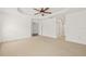 Large bedroom with tray ceiling, fan, neutral carpet, and multiple doorways at 6211 S Macdill Ave # 1, Tampa, FL 33611