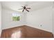 Bedroom with hardwood floors, a ceiling fan, and a window with shutter blinds at 6211 S Macdill Ave # 1, Tampa, FL 33611