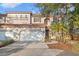 Charming two-story home with a red tile roof, two-car garage, and landscaped front yard at 6211 S Macdill Ave # 1, Tampa, FL 33611