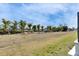 A serene backyard with waterfront access, palm trees and new construction at 6538 Simone Shores Cir, Apollo Beach, FL 33572