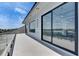 Expansive balcony features glass railings and modern finishes, showcasing views of the outdoor area at 6538 Simone Shores Cir, Apollo Beach, FL 33572