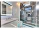 Stylish bathroom with a marble countertop sink, a toilet, and a modern glass-enclosed shower at 6538 Simone Shores Cir, Apollo Beach, FL 33572