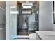 Modern bathroom featuring a luxurious glass shower with marble tiling and a sleek white vanity at 6538 Simone Shores Cir, Apollo Beach, FL 33572
