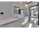 A modern bathroom features a double sink vanity, large mirror, and light tile floors at 6538 Simone Shores Cir, Apollo Beach, FL 33572