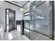 Bathroom features a glass shower with a rain shower head, modern tub, and marble accents at 6538 Simone Shores Cir, Apollo Beach, FL 33572