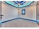 Cozy bedroom with gray carpet, a ceiling fan, and a black-framed window at 6538 Simone Shores Cir, Apollo Beach, FL 33572