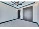 Well-lit bedroom with gray carpeting, stylish closet doors, and a contemporary ceiling fan at 6538 Simone Shores Cir, Apollo Beach, FL 33572