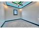 Comfortable bedroom with gray carpet, a ceiling fan, and a black-framed window at 6538 Simone Shores Cir, Apollo Beach, FL 33572
