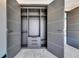 This walk-in closet features open shelving, drawers, and modern doors with sleek hardware at 6538 Simone Shores Cir, Apollo Beach, FL 33572