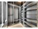 A beautifully lit walk-in closet with dark wood shelving and plenty of space at 6538 Simone Shores Cir, Apollo Beach, FL 33572