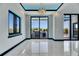 Bright dining area with elegant lighting and access to an outdoor kitchen and grill at 6538 Simone Shores Cir, Apollo Beach, FL 33572