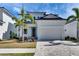 Beautiful two-story house with manicured lawn, palm trees, and a spacious two-car garage at 6538 Simone Shores Cir, Apollo Beach, FL 33572