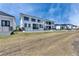 Expansive backyard featuring a lush green space, luxury homes, and a beautiful sky at 6538 Simone Shores Cir, Apollo Beach, FL 33572