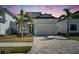 Striking two-story home with a brick driveway, well-maintained landscaping, and a two-car garage at 6538 Simone Shores Cir, Apollo Beach, FL 33572