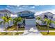Beautiful two-story light blue home with a modern design and well-manicured landscaping at 6538 Simone Shores Cir, Apollo Beach, FL 33572