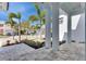 A covered porch with stone pavers and a view of the street with palm trees at 6538 Simone Shores Cir, Apollo Beach, FL 33572