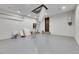 Spacious garage featuring epoxy flooring, ample lighting, and convenient access to the attic via ladder at 6538 Simone Shores Cir, Apollo Beach, FL 33572
