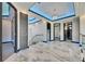Well-lit hallway with tray ceilings, elegant chandeliers, and marble floors at 6538 Simone Shores Cir, Apollo Beach, FL 33572