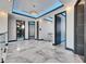 Bright upstairs hallway with tray ceiling, chandelier, and dark trim doors at 6538 Simone Shores Cir, Apollo Beach, FL 33572