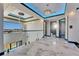 Hallway with chandelier, glass railings, and dark-trimmed doorways at 6538 Simone Shores Cir, Apollo Beach, FL 33572
