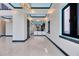 Bright hallway with elegant lighting that leads to a modern kitchen with bar seating at 6538 Simone Shores Cir, Apollo Beach, FL 33572