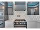Modern gas range and pot filler accentuate this well-lit luxury kitchen at 6538 Simone Shores Cir, Apollo Beach, FL 33572