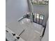 A high angle view of a modern open living area with large windows and sleek floors at 6538 Simone Shores Cir, Apollo Beach, FL 33572