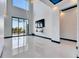 Bright living room features high ceilings, luxury flooring, and access to an outdoor balcony at 6538 Simone Shores Cir, Apollo Beach, FL 33572