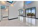 Bright living room features high ceilings, luxury flooring, and access to an outdoor balcony at 6538 Simone Shores Cir, Apollo Beach, FL 33572