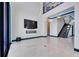Bright living room featuring a fireplace, TV, and staircase with glass railing at 6538 Simone Shores Cir, Apollo Beach, FL 33572