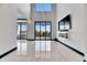 Bright living room features high ceilings, luxury flooring, and access to an outdoor balcony at 6538 Simone Shores Cir, Apollo Beach, FL 33572