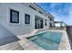 Stunning backyard view featuring a modern pool, jacuzzi, and home with sleek architecture at 6538 Simone Shores Cir, Apollo Beach, FL 33572