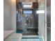 This modern glass-enclosed shower features sleek fixtures and a built-in seat at 6538 Simone Shores Cir, Apollo Beach, FL 33572